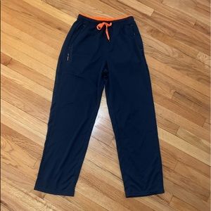 Navy blue men’s sweatpants with orange details.